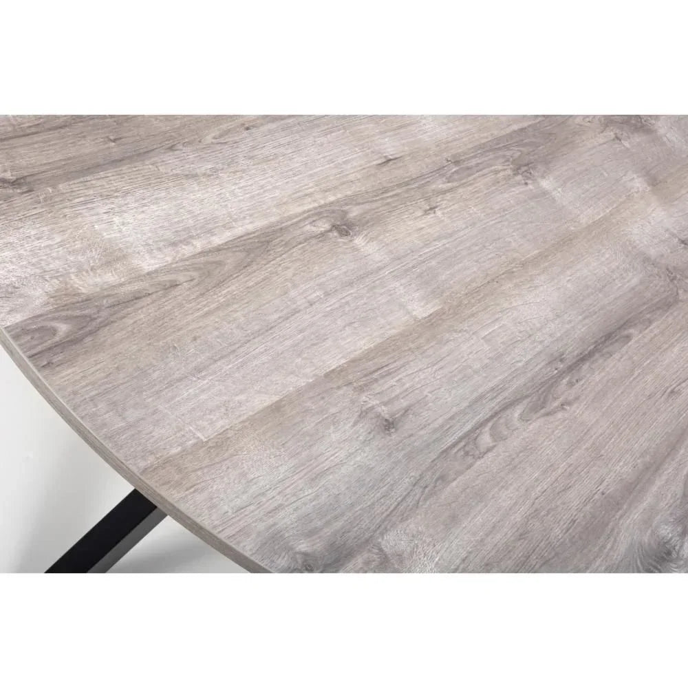 Light oak dining table top with natural wood grain and black metal leg visible underneath