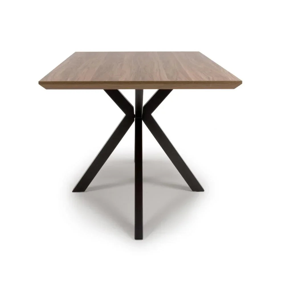 Square dining table with wood top and black metal cross base, front angle