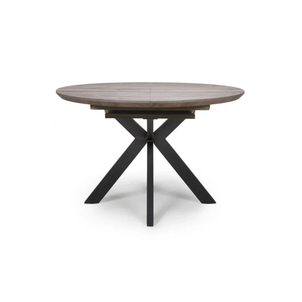 Round wooden dining table with black metal cross legs, front view