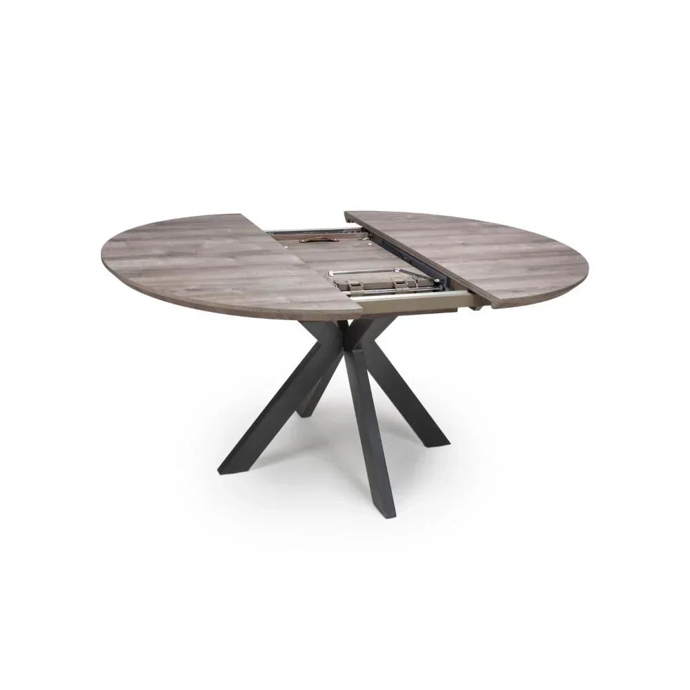 Round extending dining table in grey wood with split top and black cross legs
