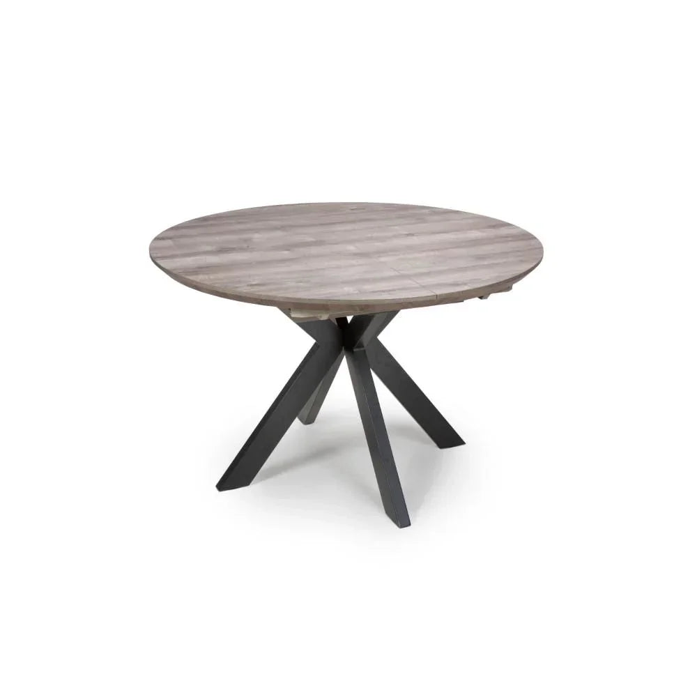 Round wood dining table with cross metal legs on white background
