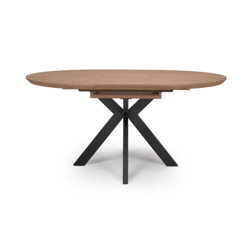Oval wooden dining table with black metal cross legs on white background