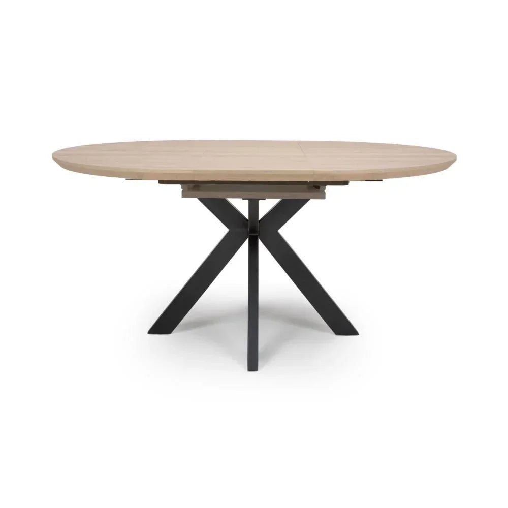 Oval dining table with light wood top and black metal cross legs, front view
