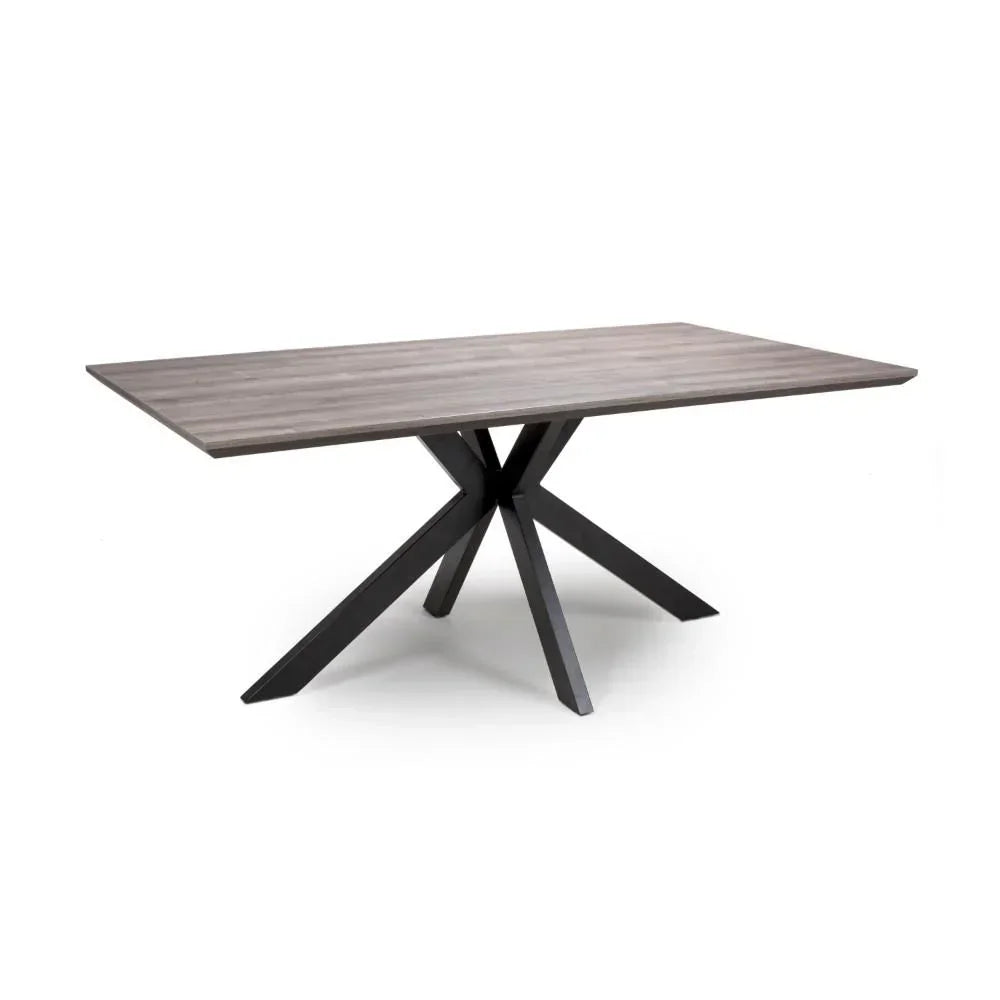 Rectangular dining table with wood finish top and black metal star-shaped base