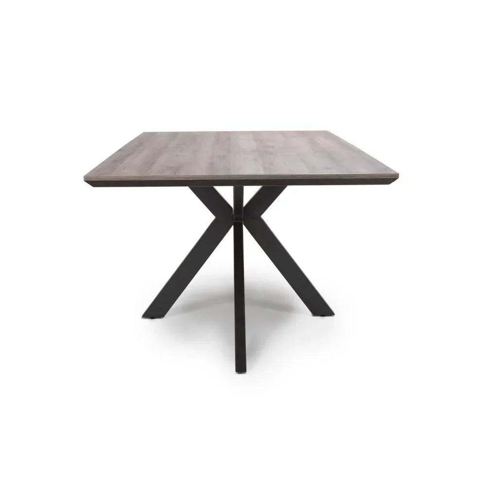 Square dining table with wooden top and black metal cross legs on white background