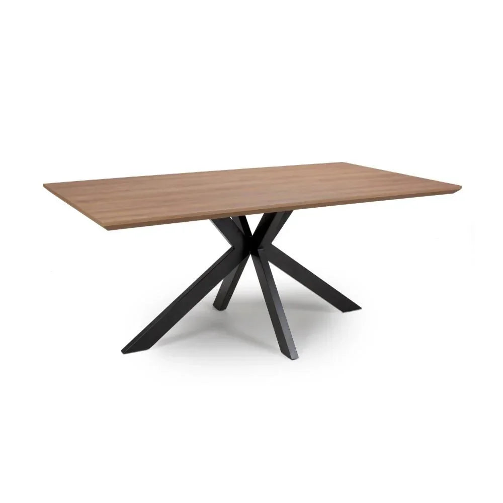rectangular dining table with wooden top and black metal star-shaped base