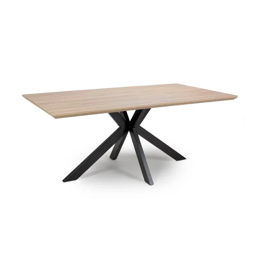 Rectangular wooden dining table with metal star-shaped legs on white background