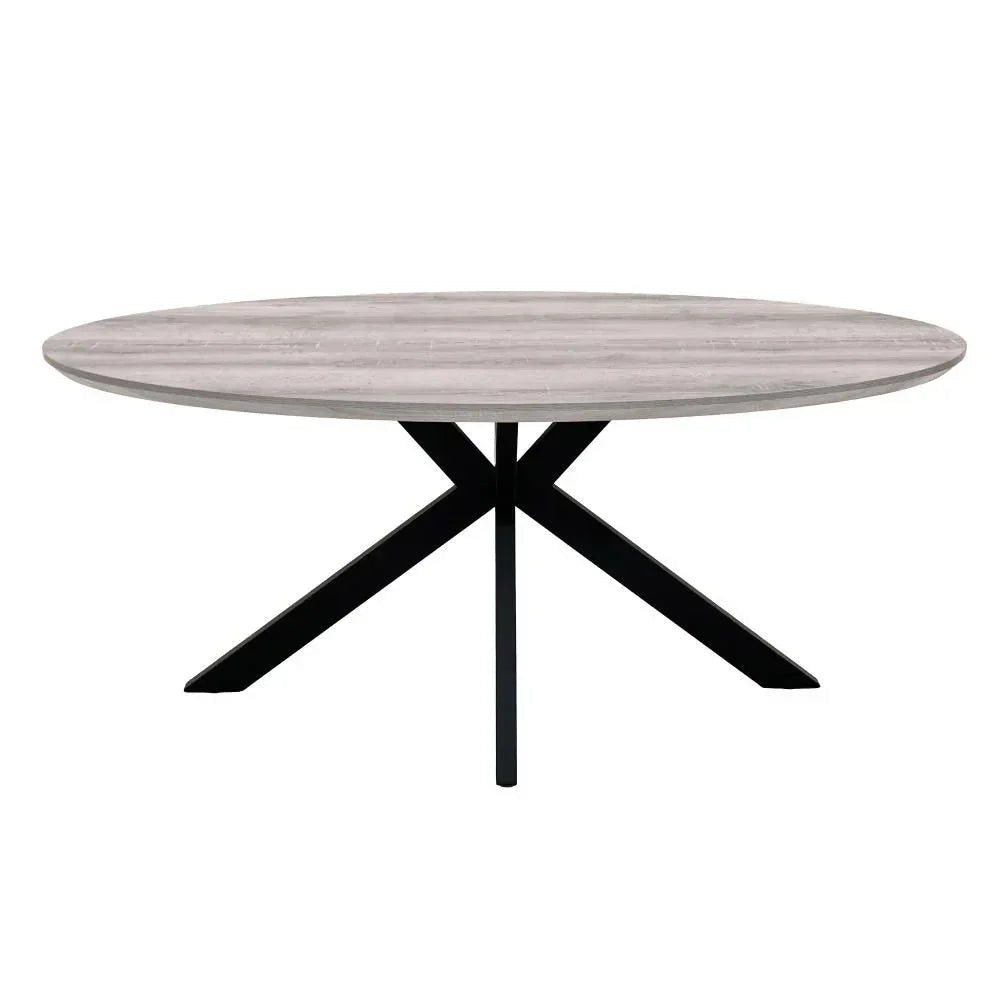 Oval dining table with light wood finish and black metal cross legs