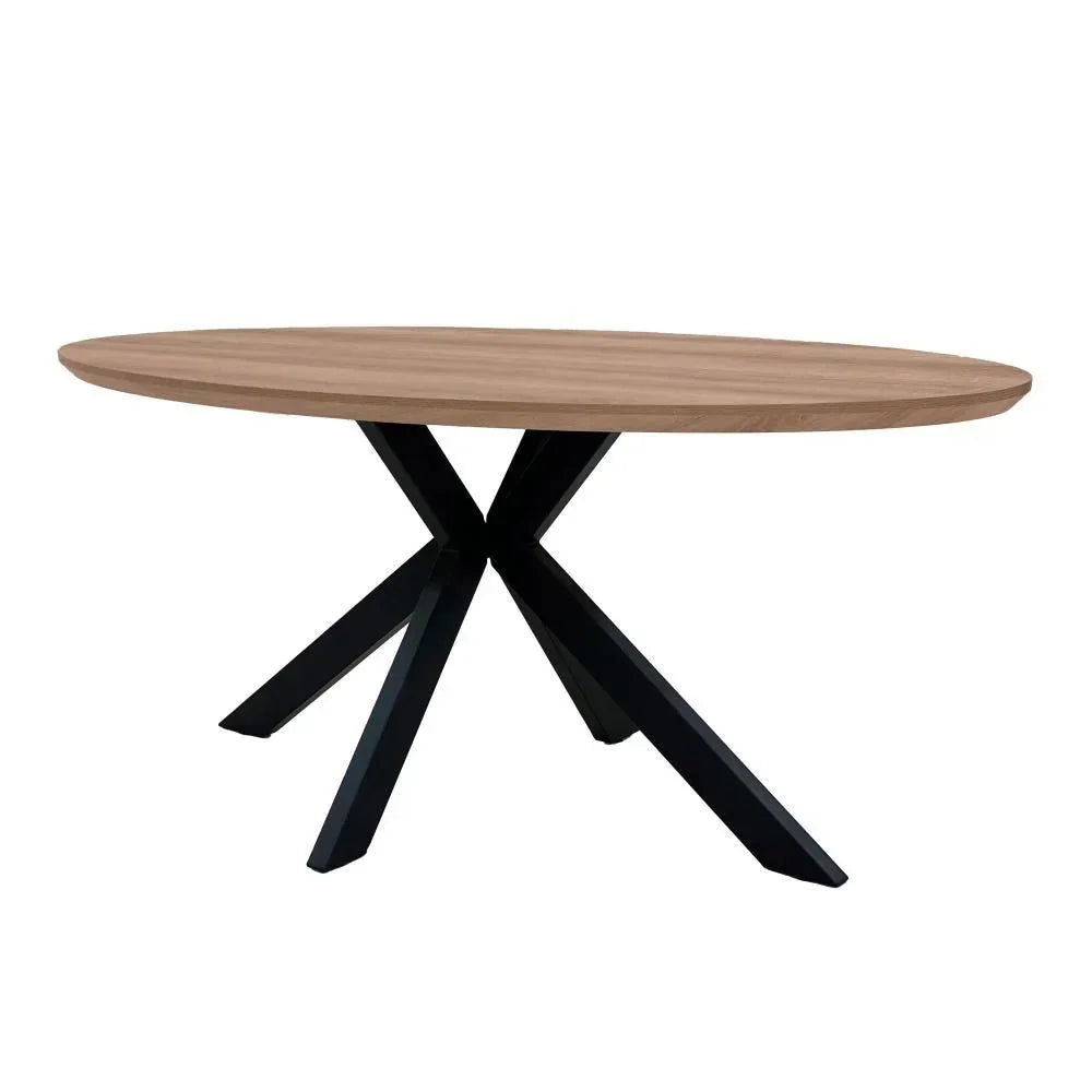 Oval wooden dining table with black crossed metal legs on white background