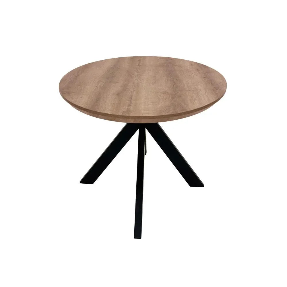 Round wooden dining table with black metal legs on white background