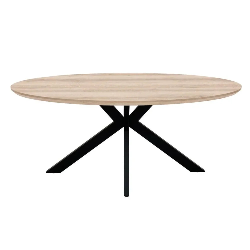 Round oak dining table with black crossed metal legs, front angle view