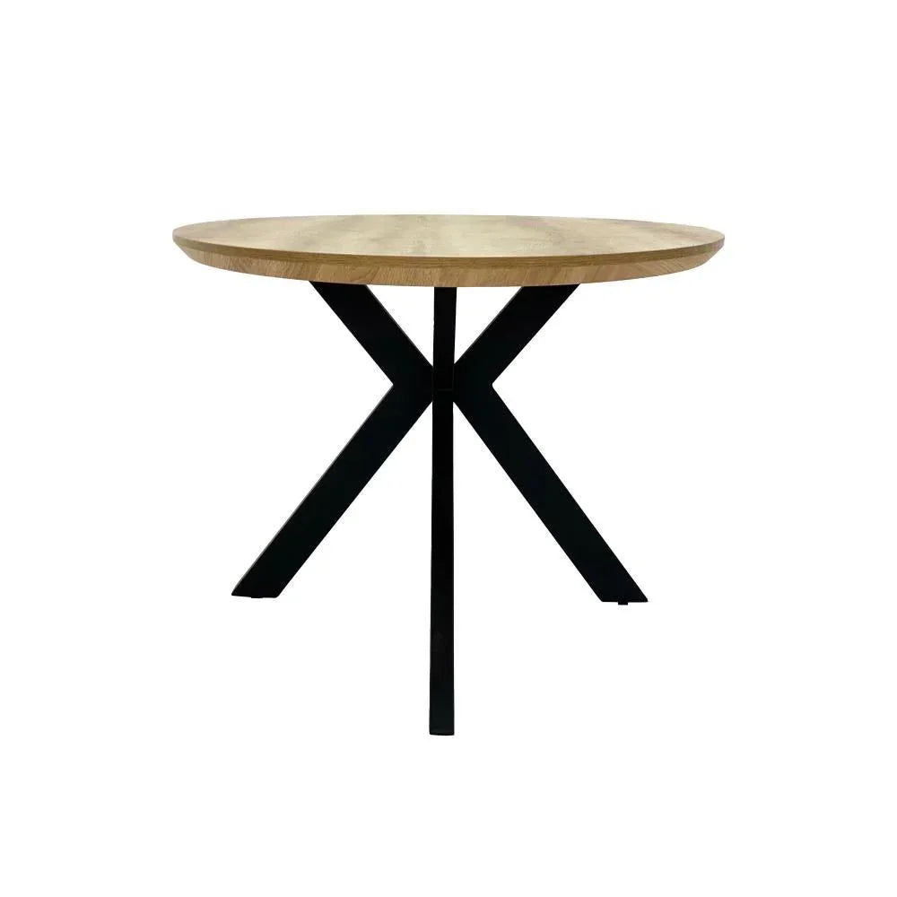 Round dining table with light wood top and black crossed metal legs, front view