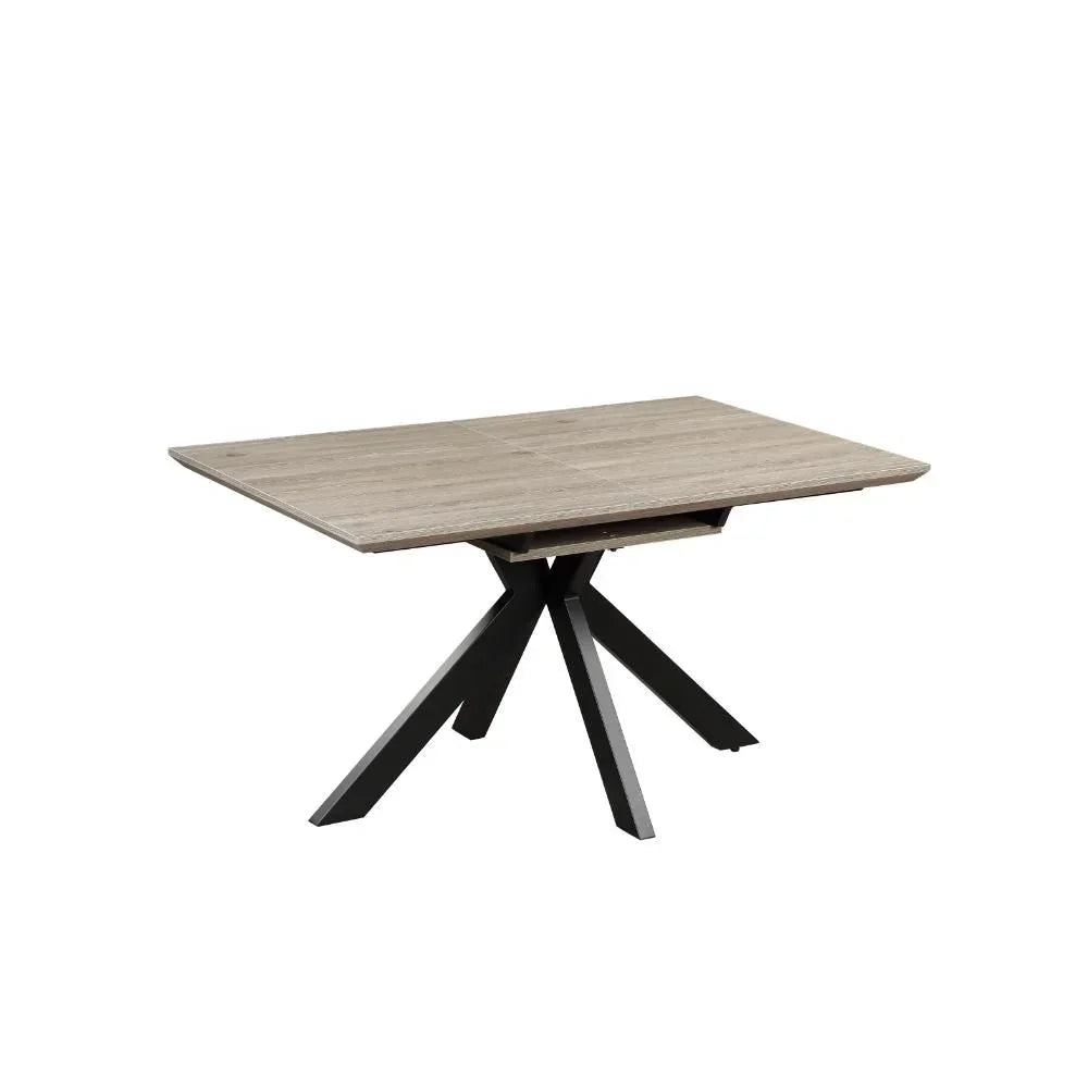 Rectangular wood dining table with black metal star base on white background