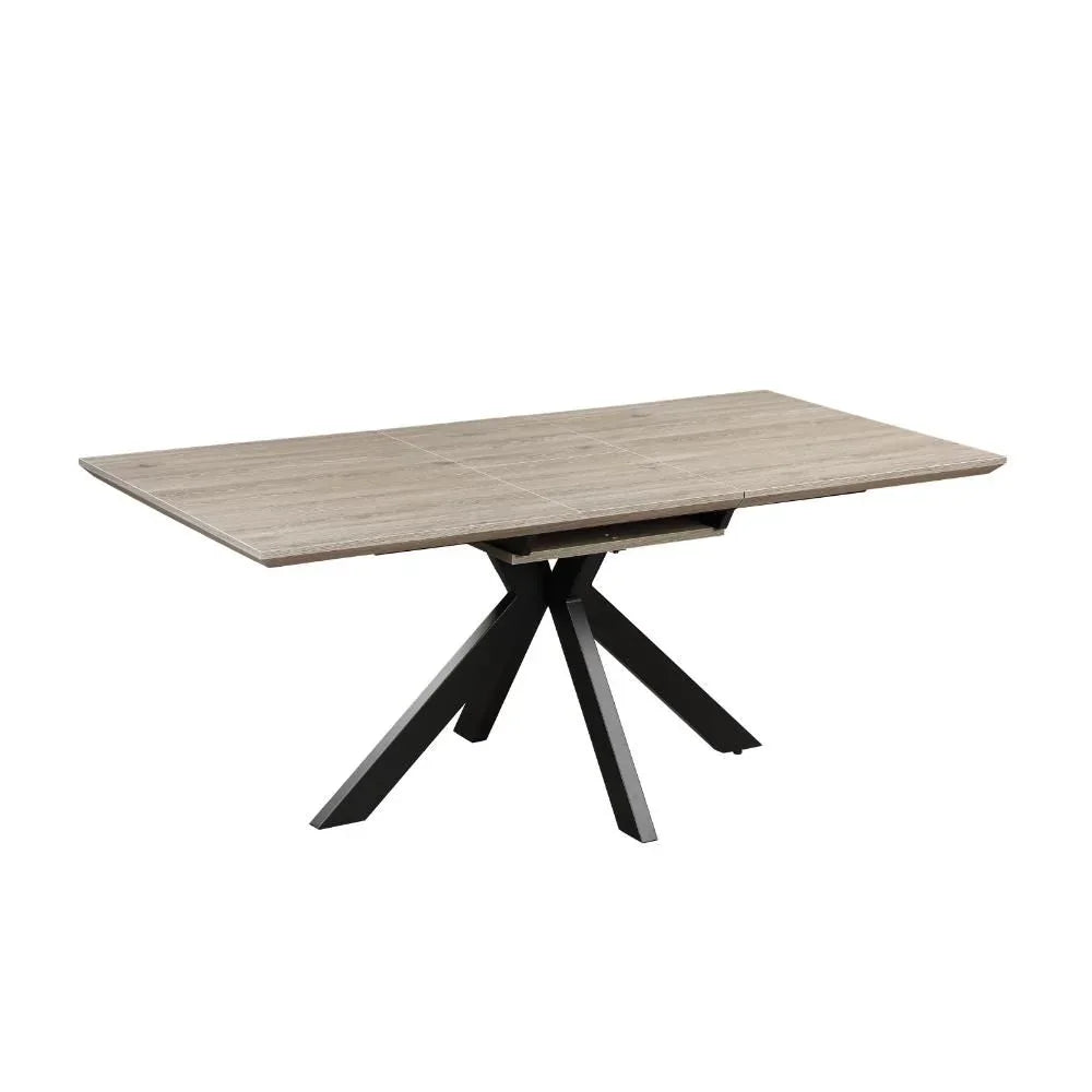 Rectangular wood dining table with black metal starburst legs on white background