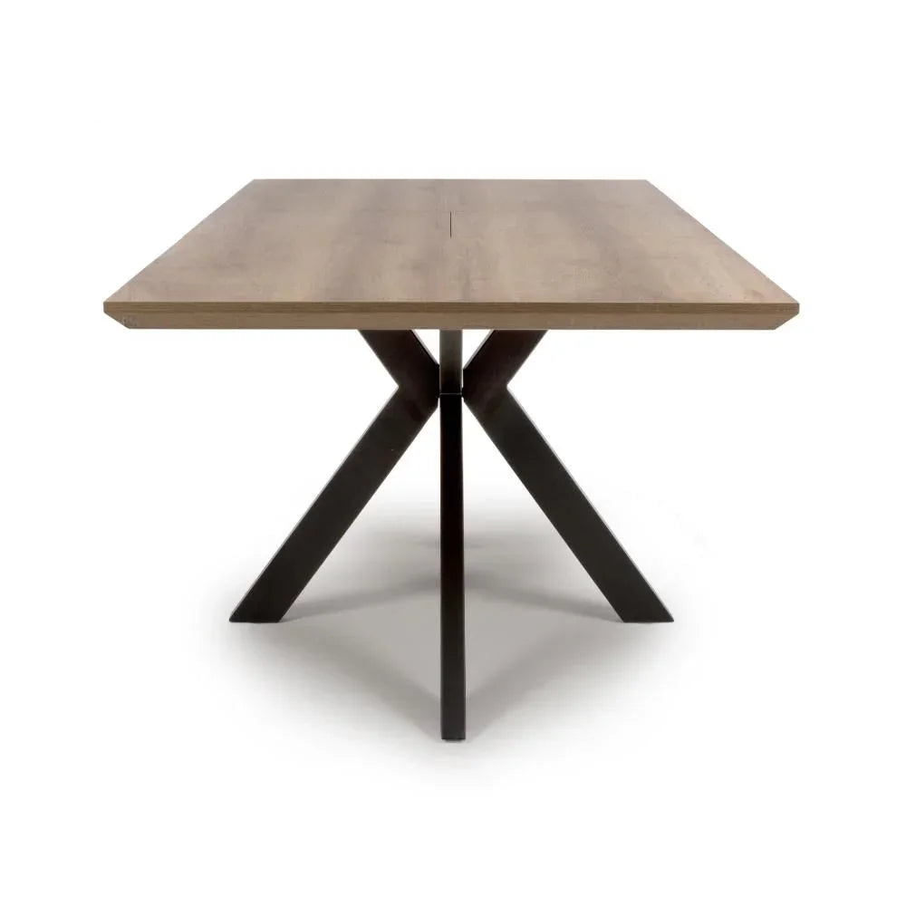 Square wooden dining table with black metal cross base, front view