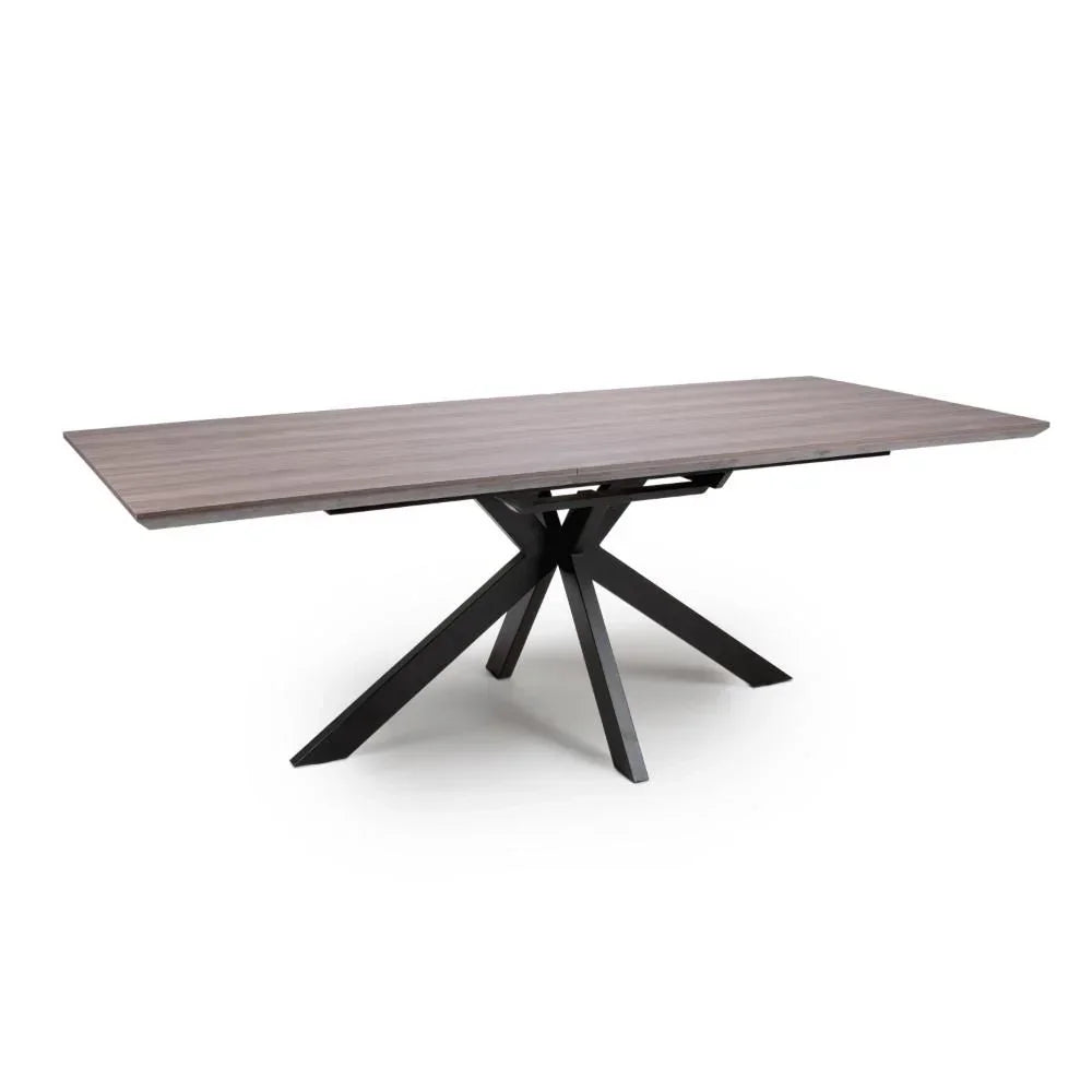 Rectangular dining table with wood effect top and black metal star-shaped base