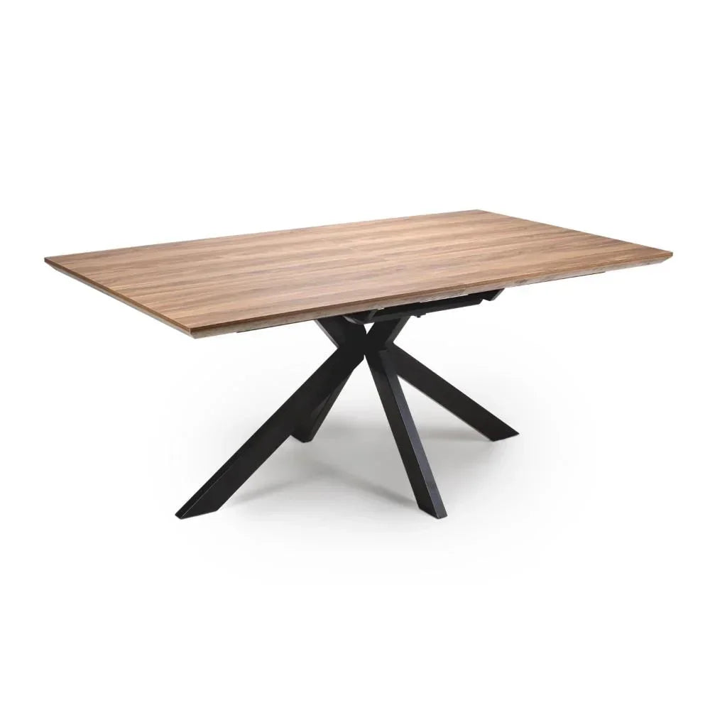 Rectangular wooden dining table with black metal spider legs on white background