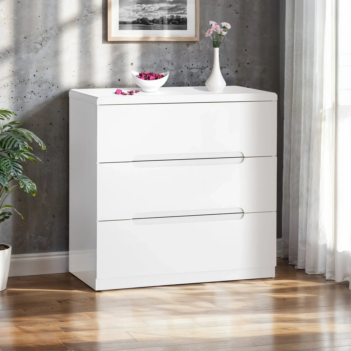 White three drawer chest of drawers with modern handles in bright bedroom corner