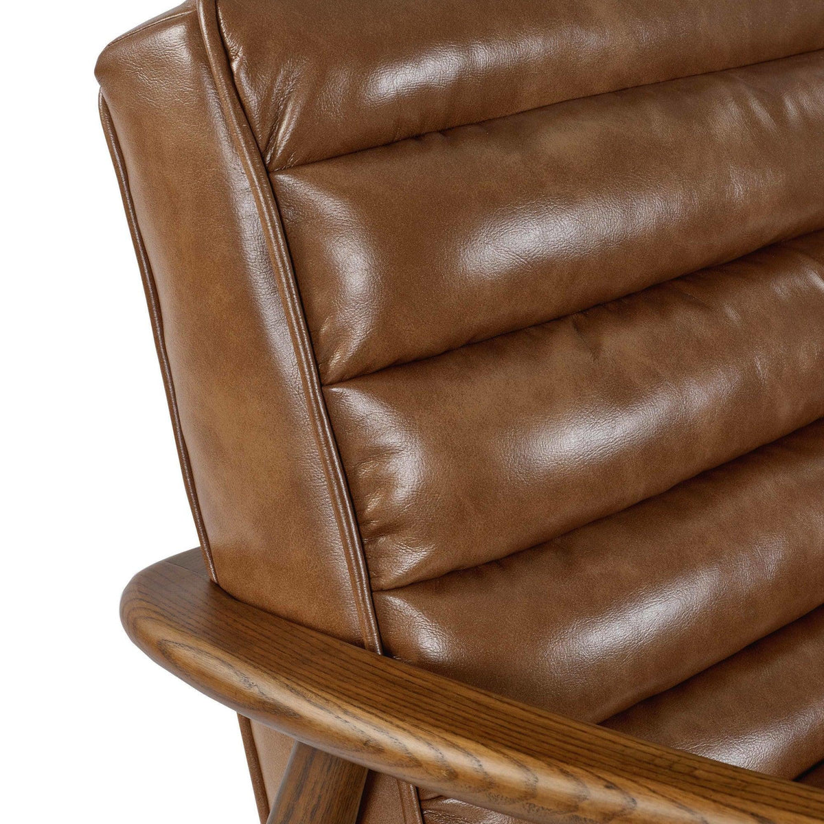 Brown leather accent chair with ribbed upholstery and curved wooden armrest close-up