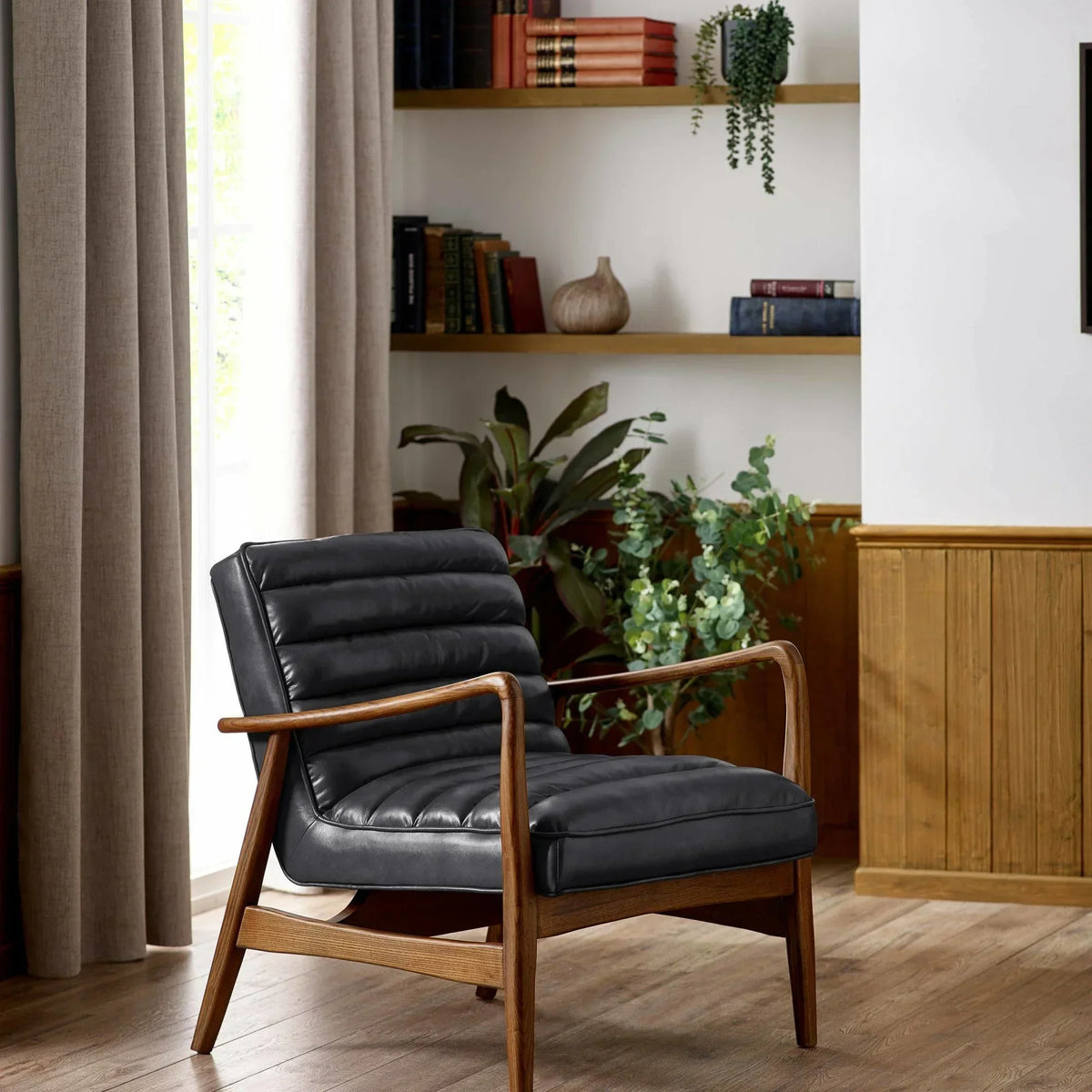 Black leather armchair with wooden frame in modern living room setting