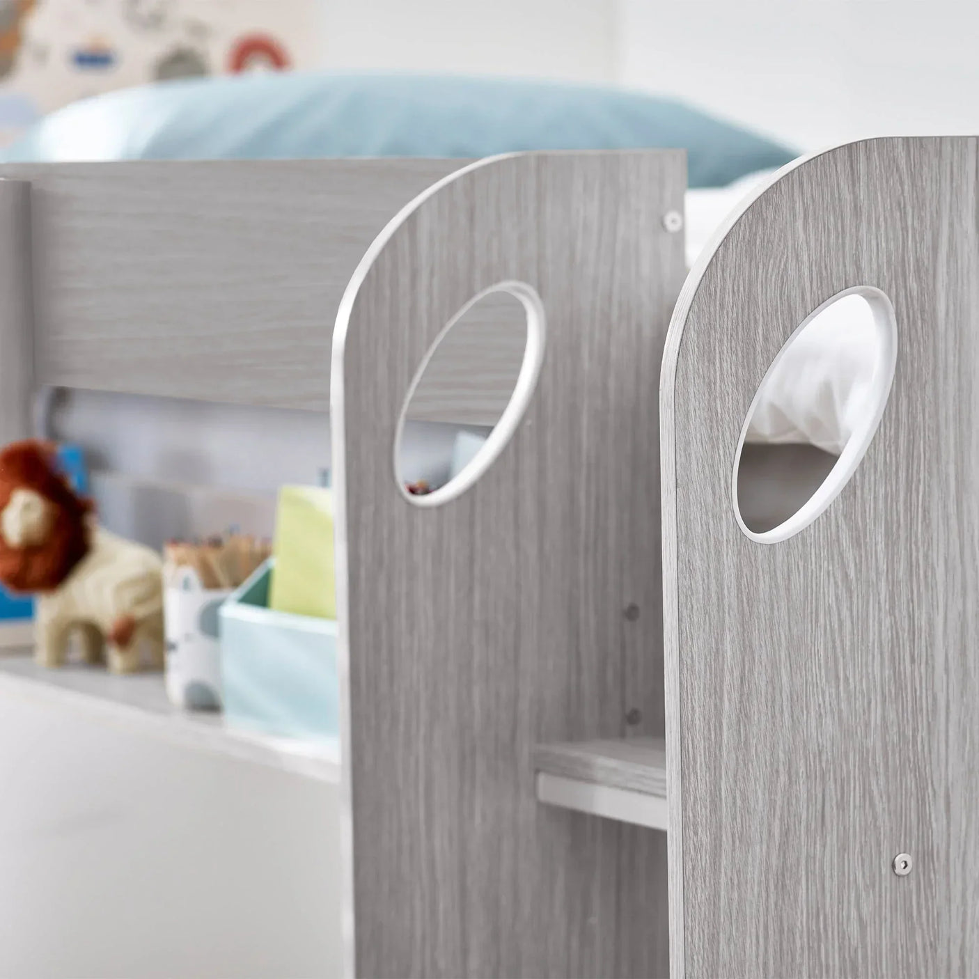 Close detail of grey oak underbed storage with cut-out handles and shelf compartments