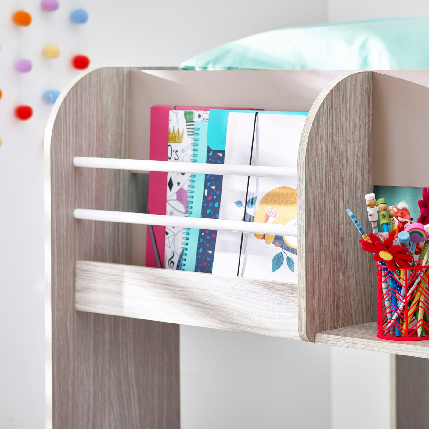 Wooden kids desk bookshelf with notebooks and pencil holder on side shelf