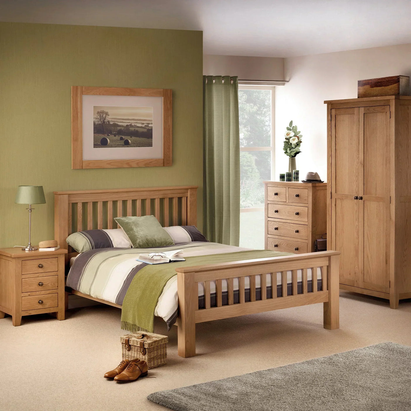 Oak 3 drawer bedside table beside bed in modern bedroom with matching wardrobe and chest