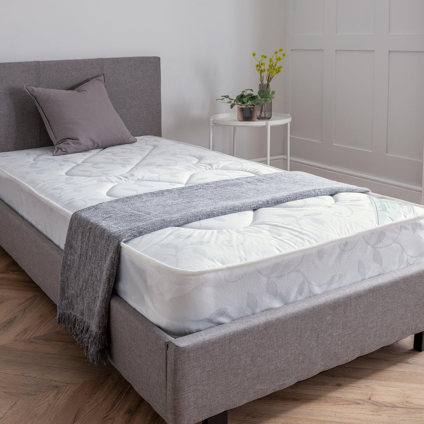 Premier 90cm single mattress on grey upholstered bed in modern bedroom with plants