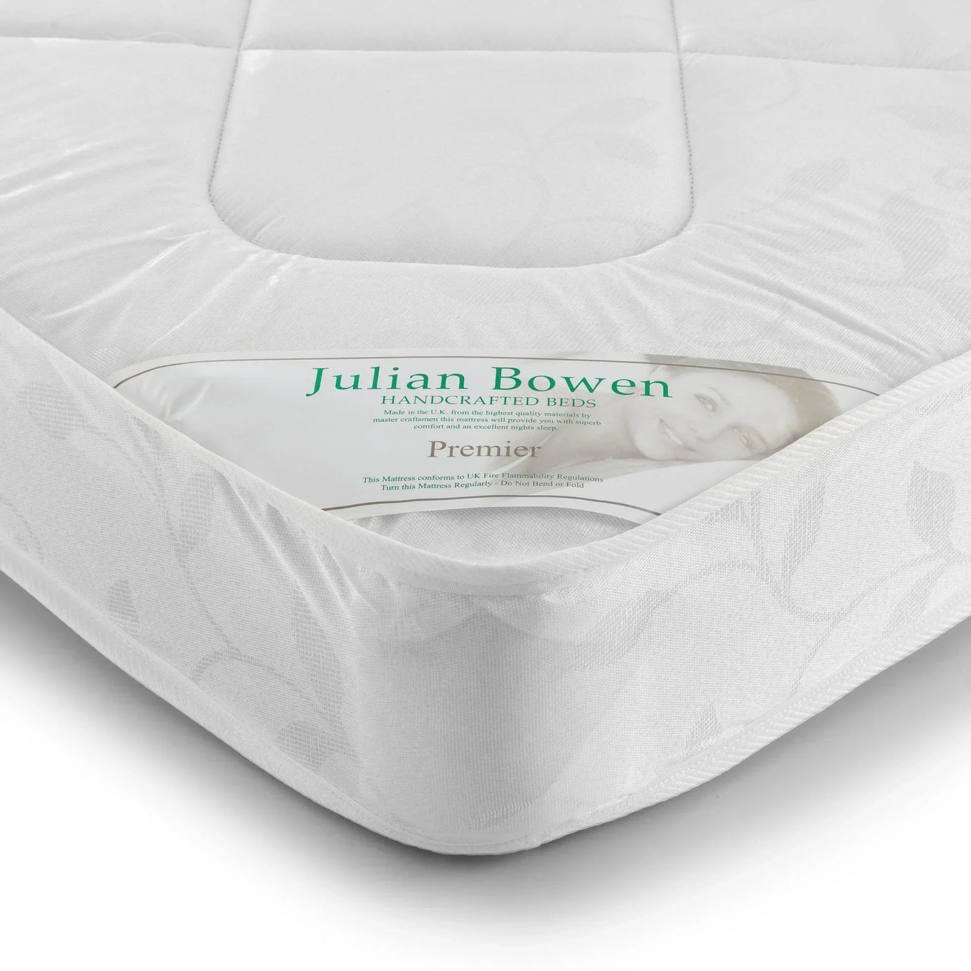 Close-up of Premier 135cm mattress corner showing white quilted fabric and label detail