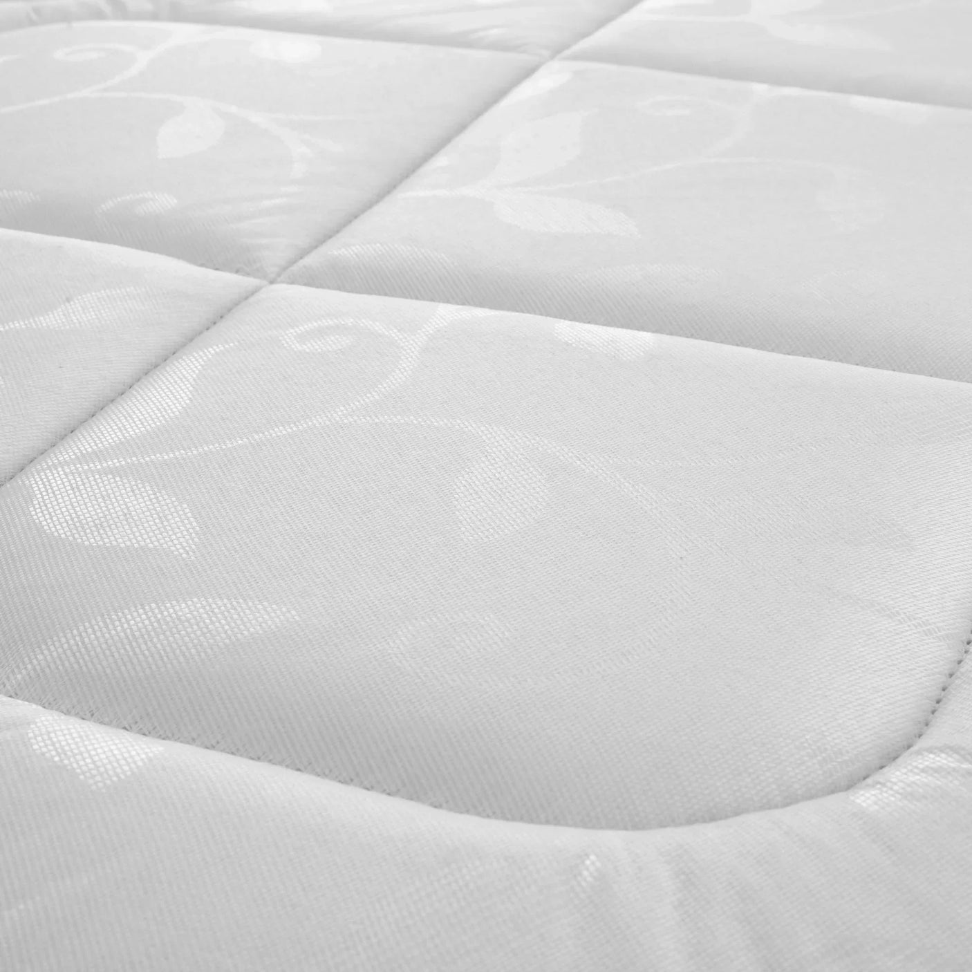 Close up of Premier mattress fabric with quilted floral stitching and soft padded surface