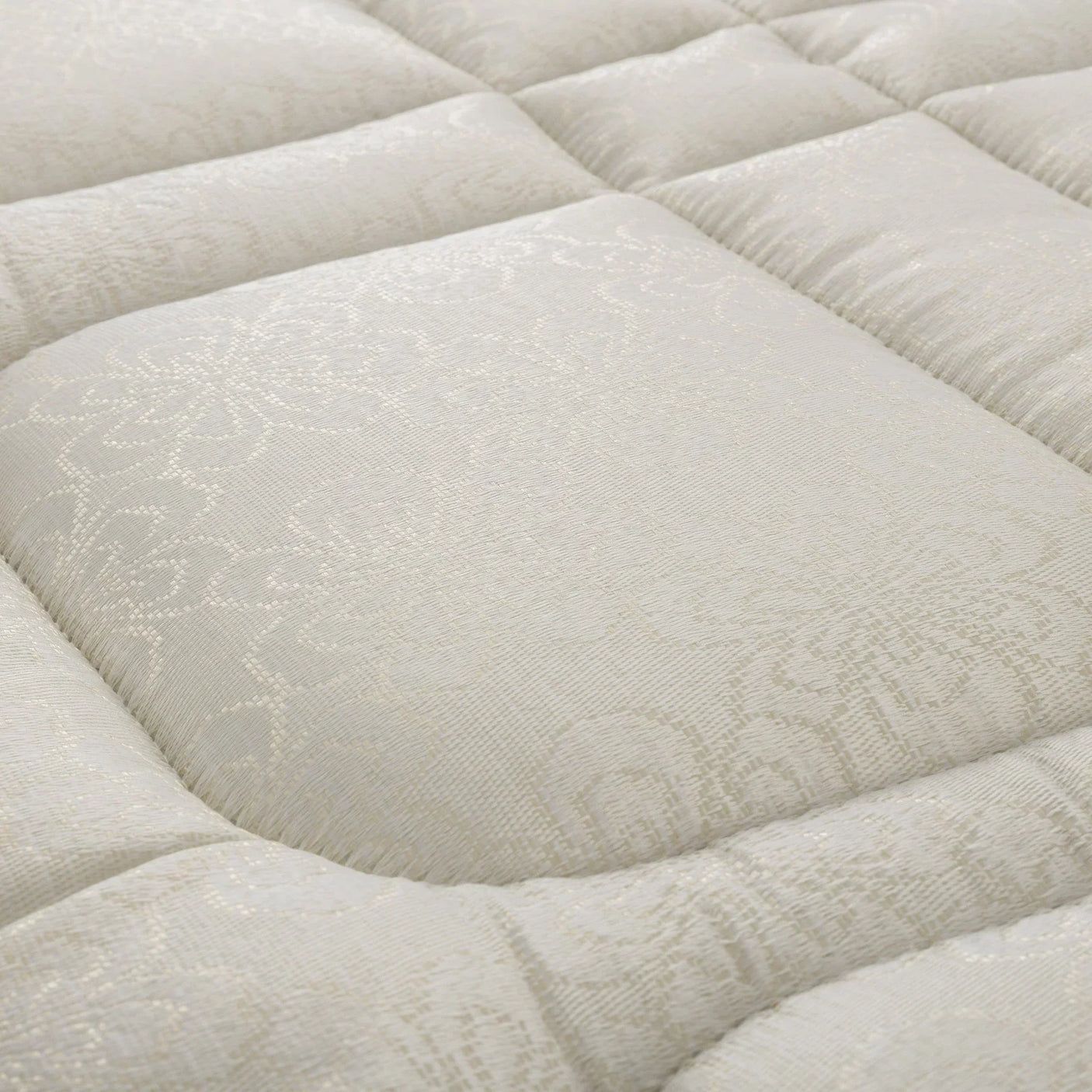 Platinum bunk mattress close-up showing quilted pattern and textured cream fabric surface