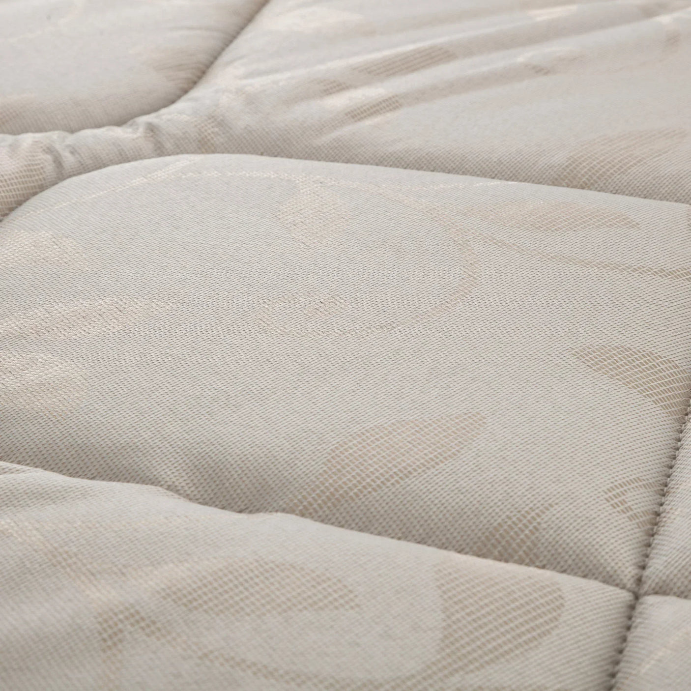 Close-up of cabin bed mattress fabric with stitched floral pattern and quilted texture