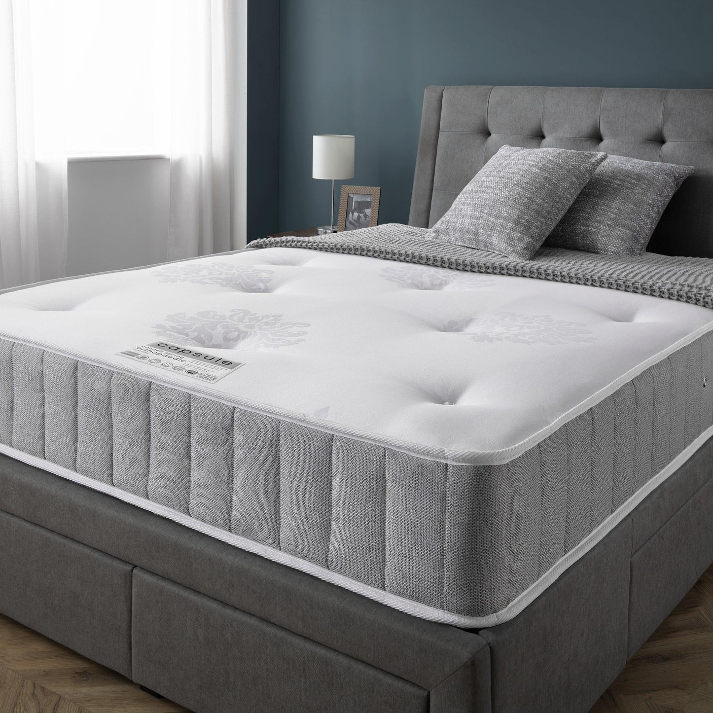 Capsule orthopaedic mattress 135cm on grey upholstered bed in modern bedroom