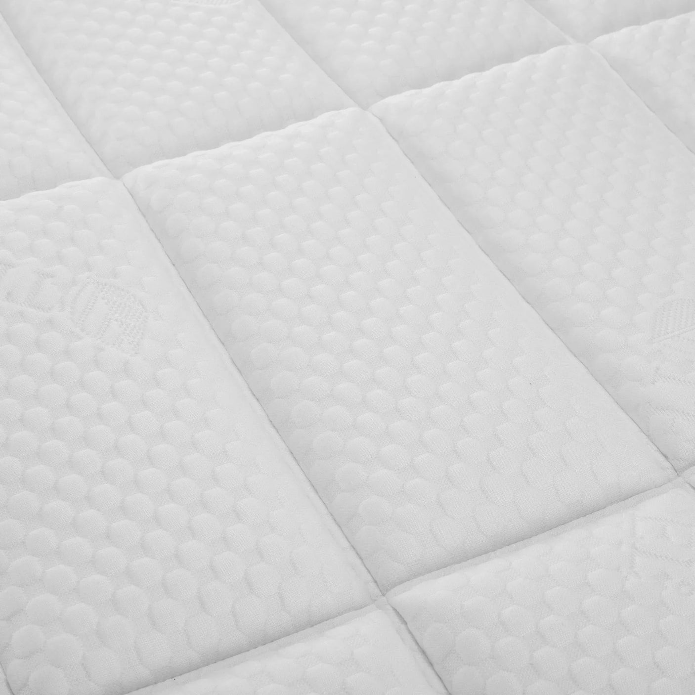Close-up of mattress 135cm with white quilted top and textured square stitching