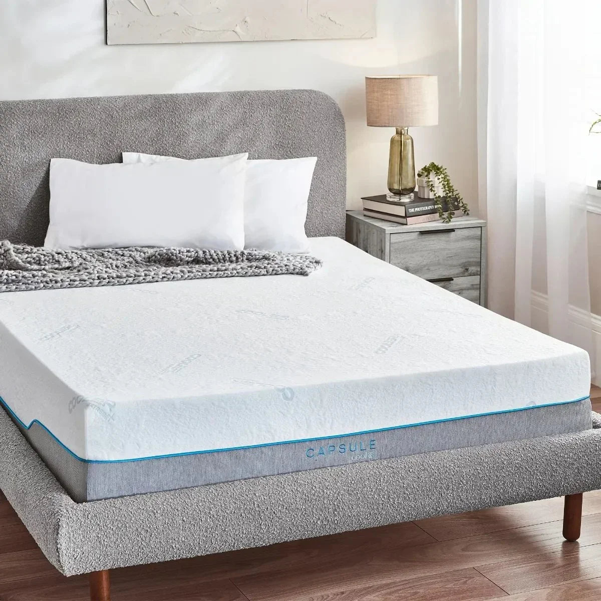 Memory foam mattress with grey upholstered bed frame in modern bedroom setting