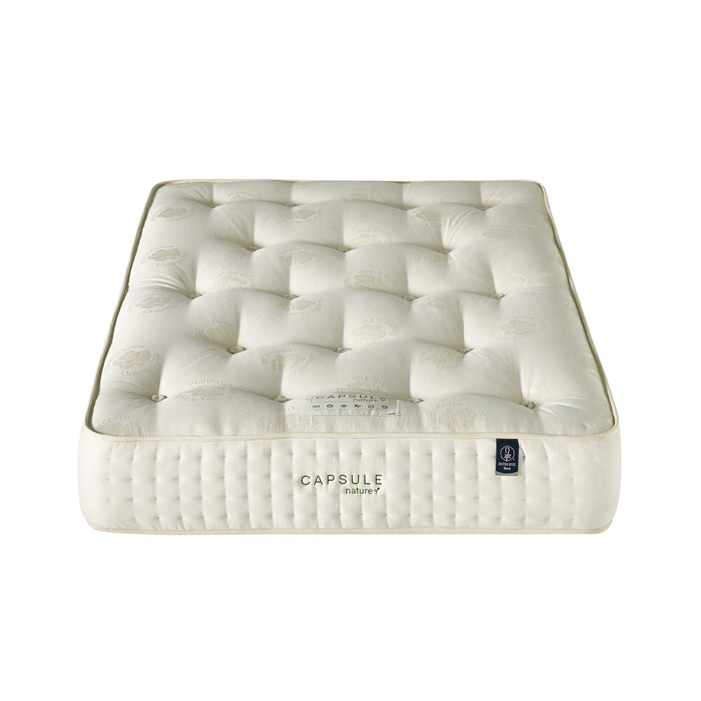 Double size mattress with tufted cream fabric cover and embroidered Capsule Nature label