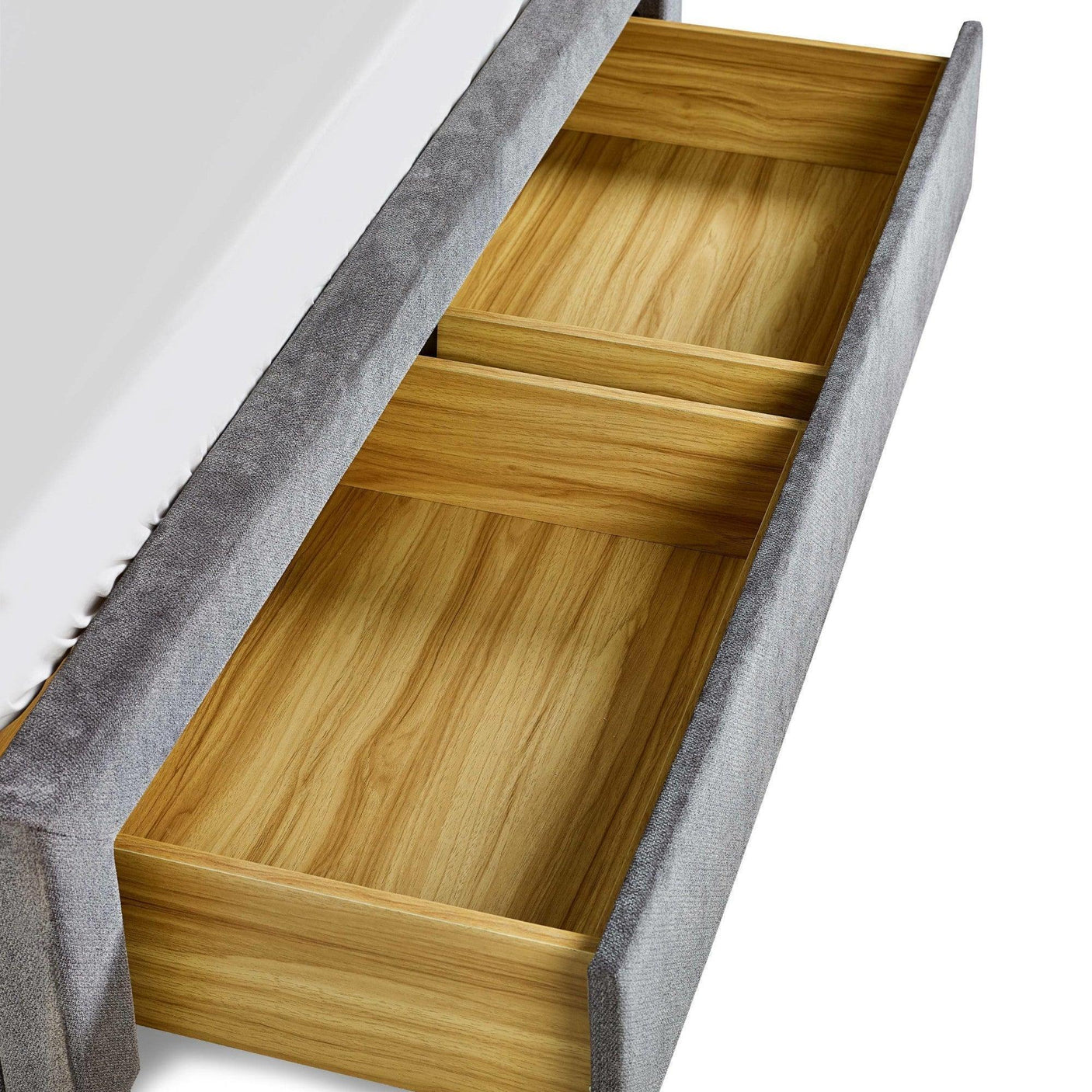 Grey upholstered bed frame with open wooden storage drawer and divider