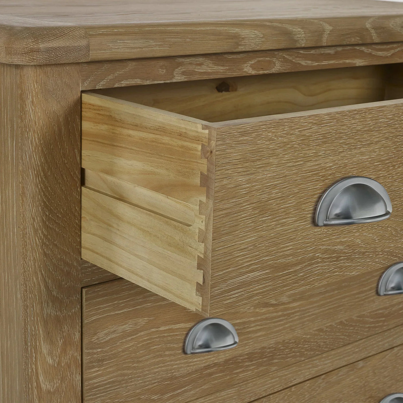 Memphis limed oak 3 drawer chest with metal cup handles, open dovetail drawer detail