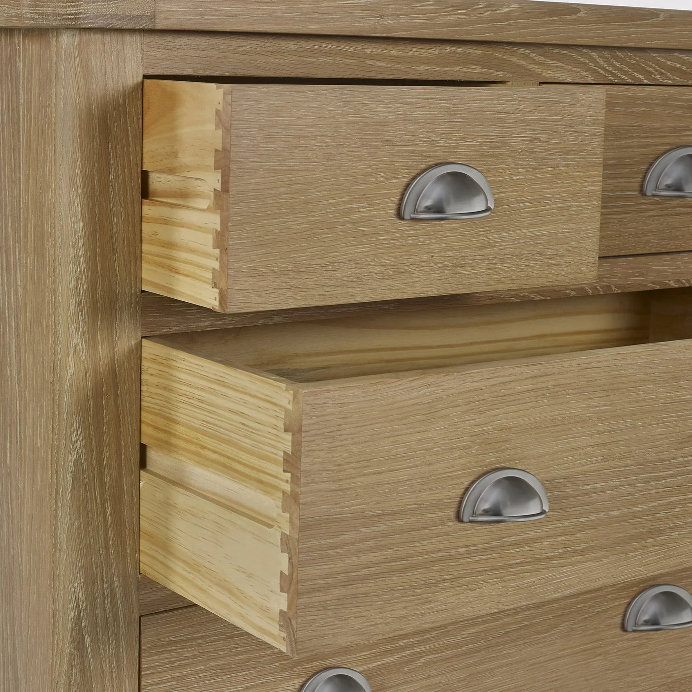 Close-up of limed oak 2 drawer chest with metal cup handles and visible dovetail joints