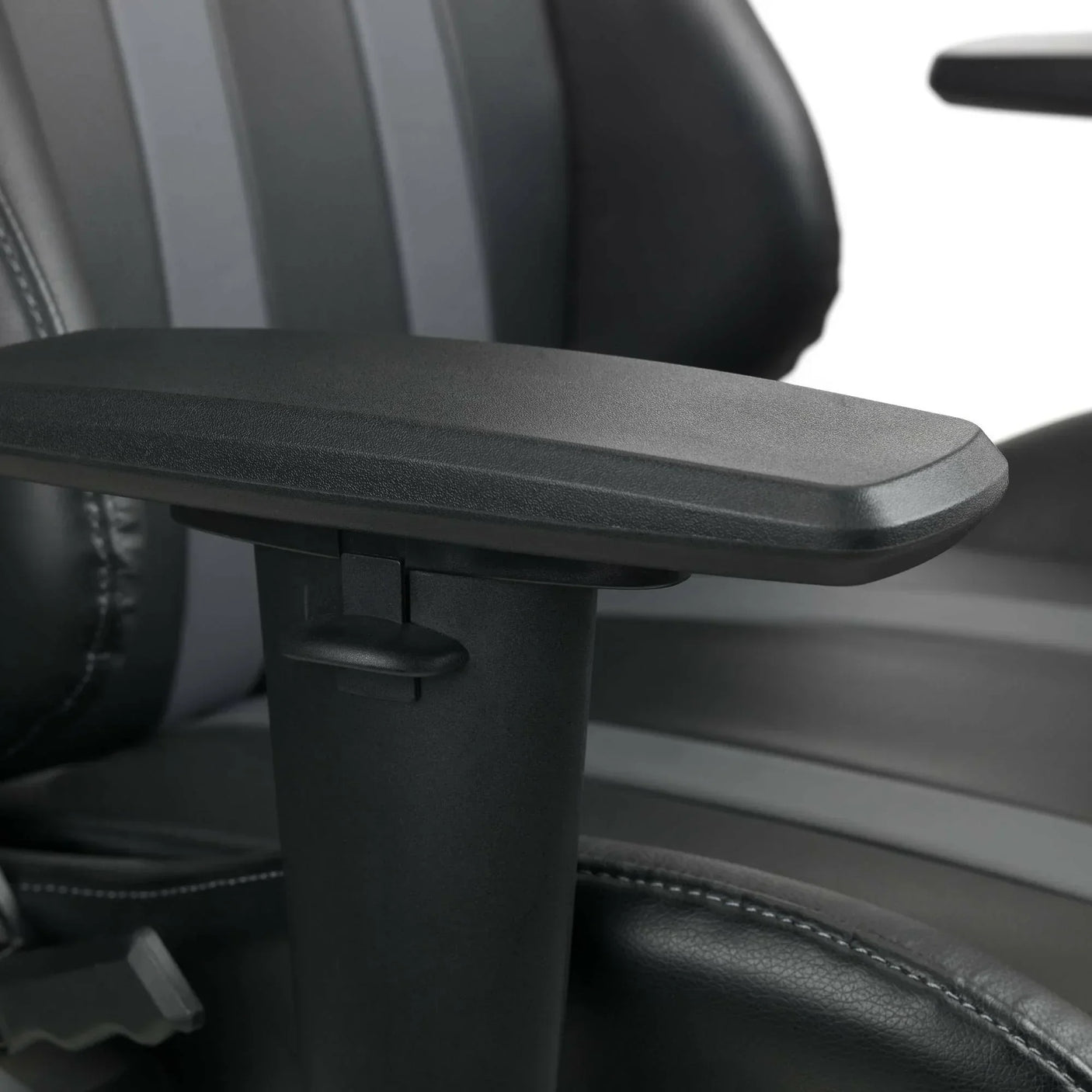Adjustable black armrest and padded seat detail on Meteor gaming chair