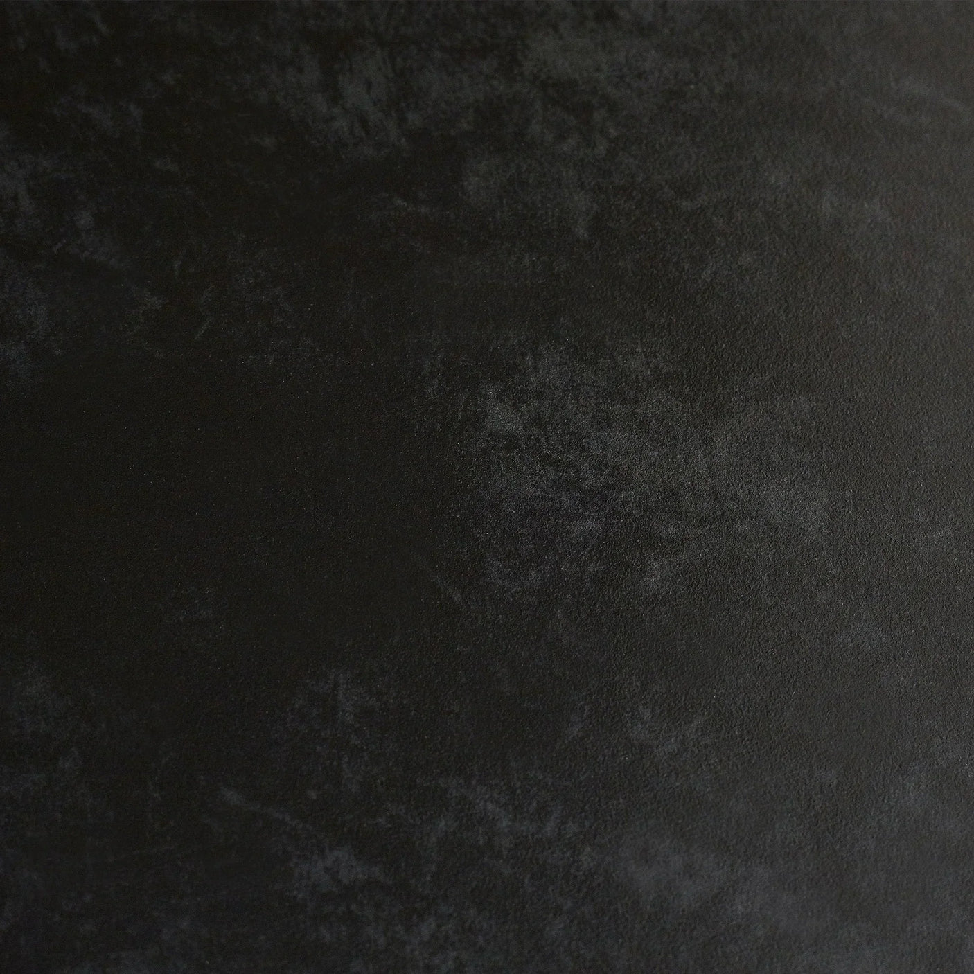 Black stone top dining table surface with natural textured finish