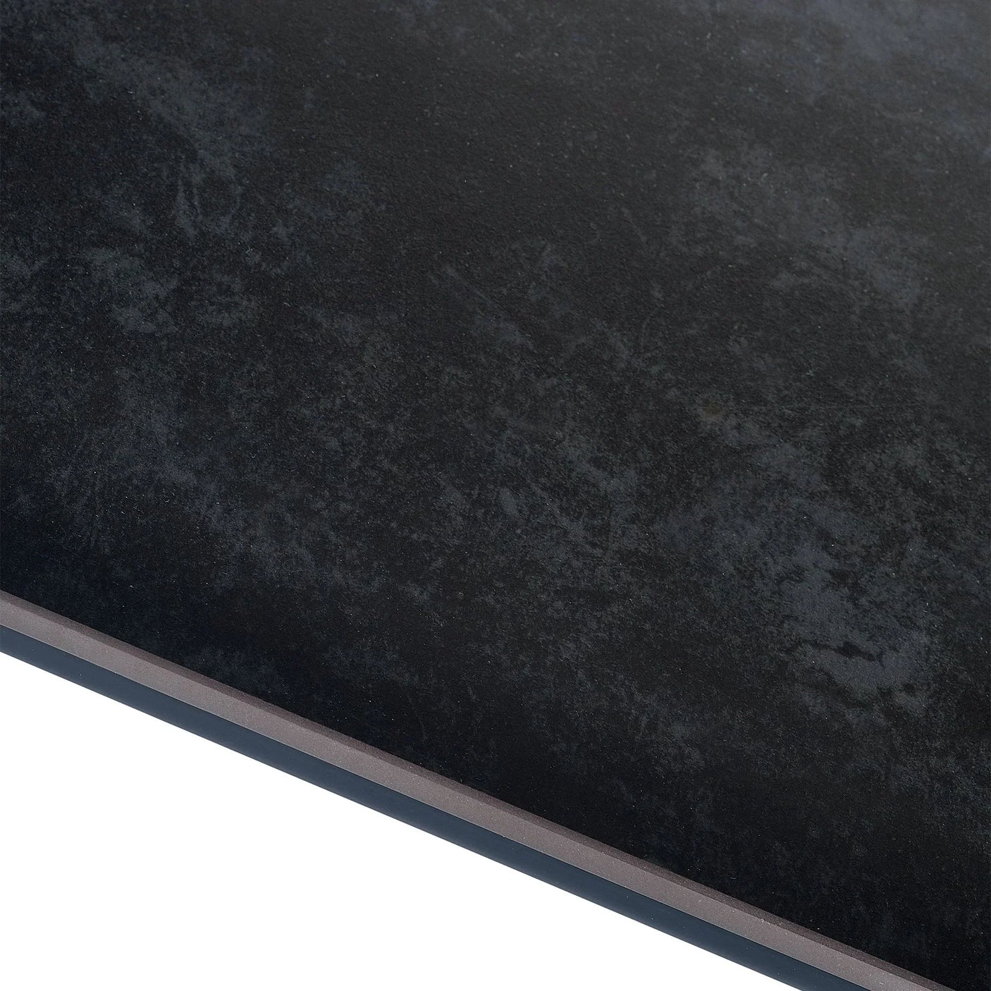 Close-up of rectangular stone dining table top with textured dark surface