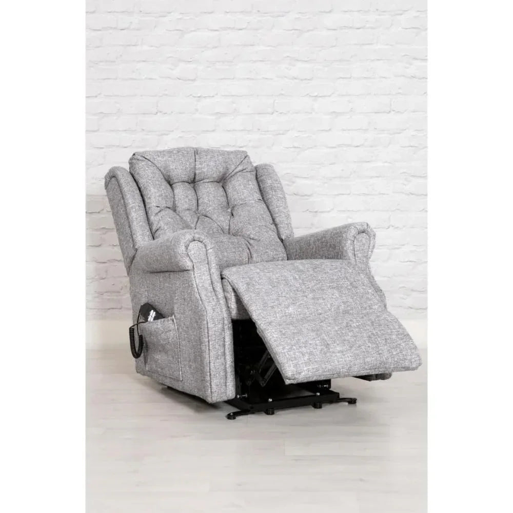 Grey fabric recliner armchair with tufted back and extended footrest on light floor