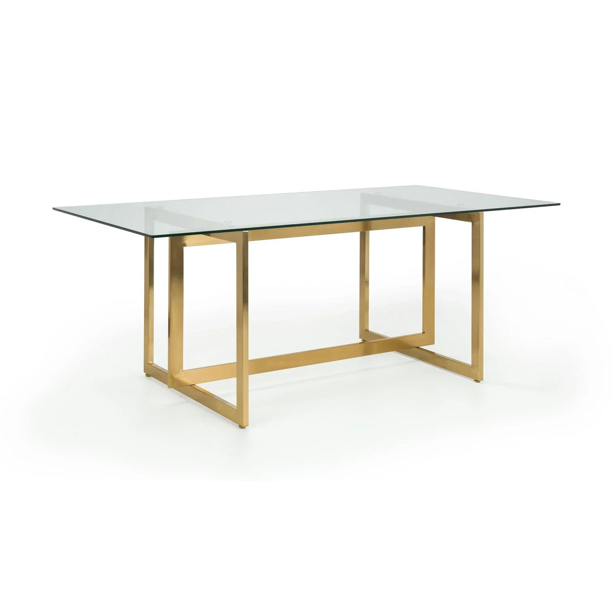Rectangular glass dining table with gold metal legs on white background