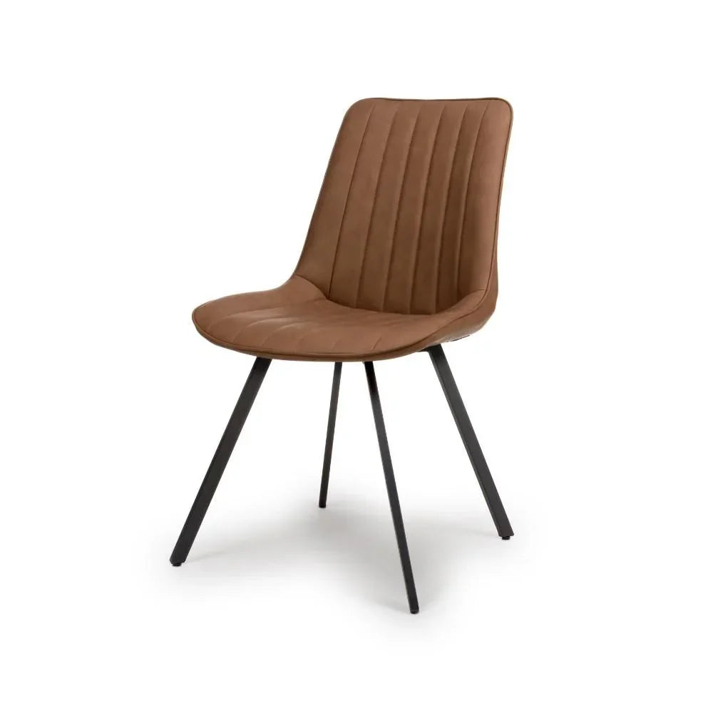 Tan dining chair with stitched seat and black angled metal legs on white background