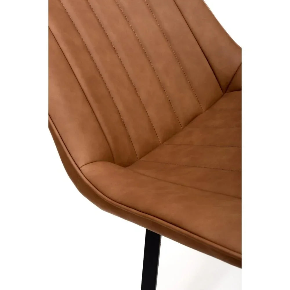 Tan faux leather dining chair with vertical stitching and black metal leg detail
