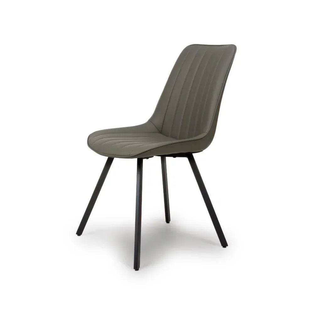 Grey dining chair with metal legs and stitched seat detail, angled side view