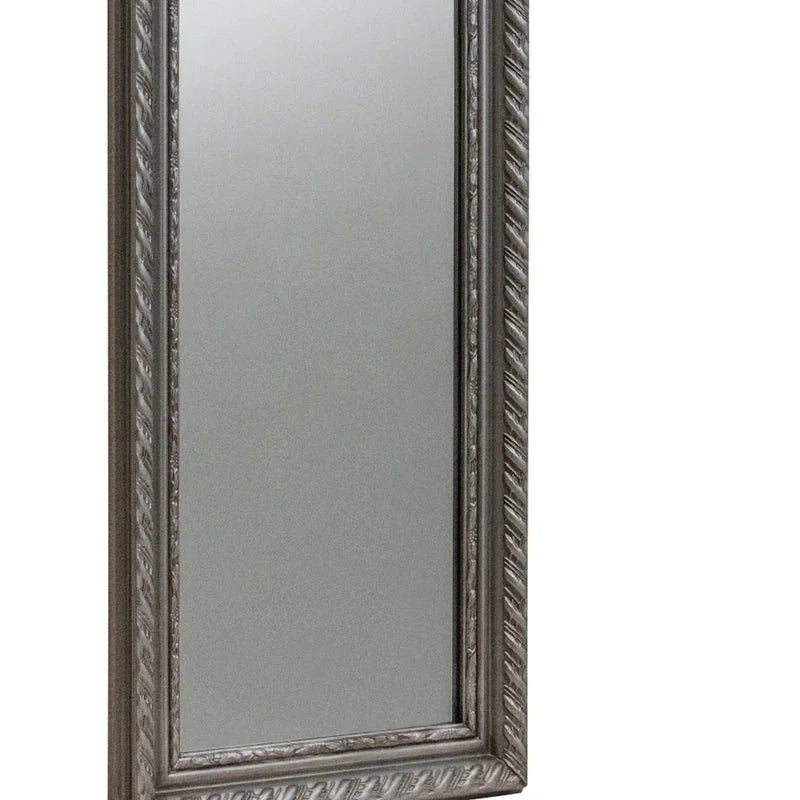 Pewter dress mirror with decorative carved frame, angled view highlighting frame detail