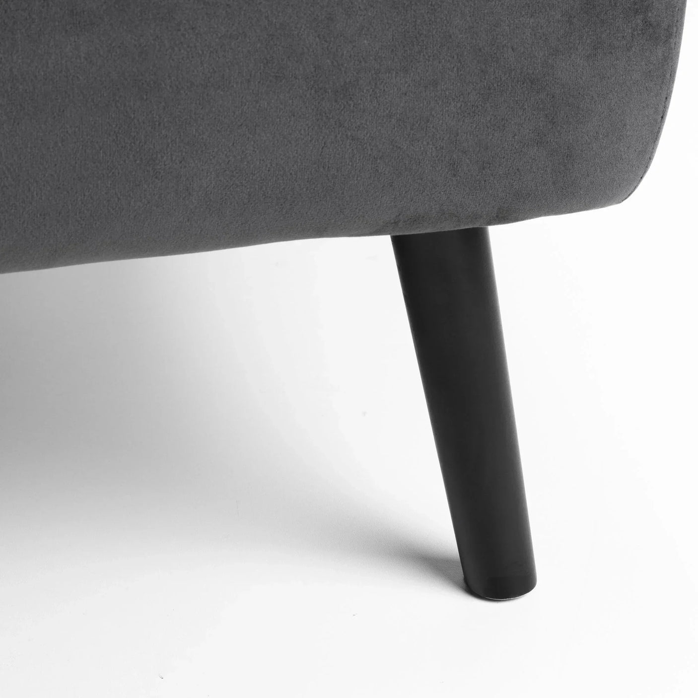 Dark wooden sofa leg with grey upholstered fabric shown against white background