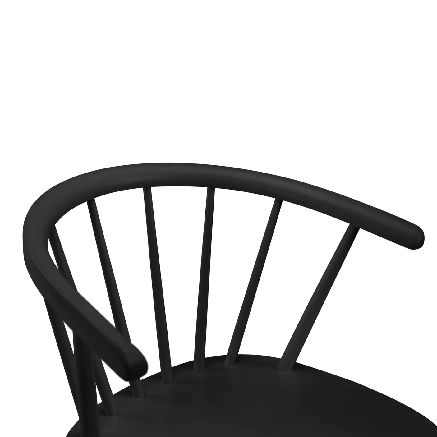 Curved backrest detail of black dining chair with spindle supports